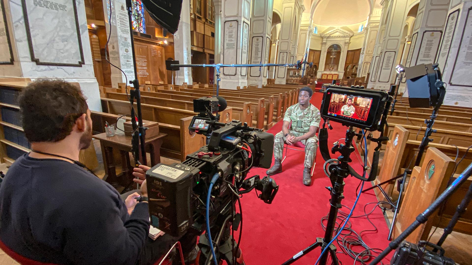 British military veteran, interview to camera in a cathedral.